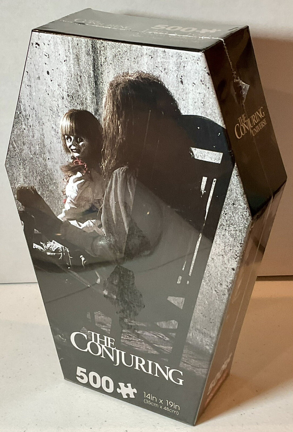 The Conjuring 500 Piece Puzzle Coffin Shaped Box includes Puzzle Art Poster